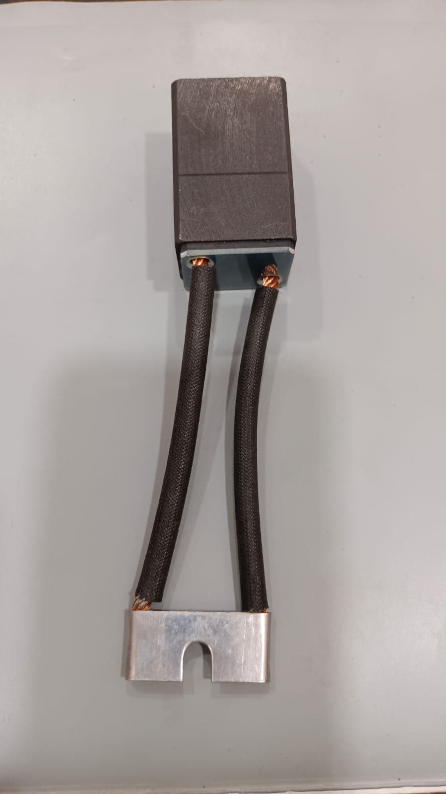 Heavy-duty carbon brush with twin braided leads and slotted terminal plate from Heena Electric Corporation