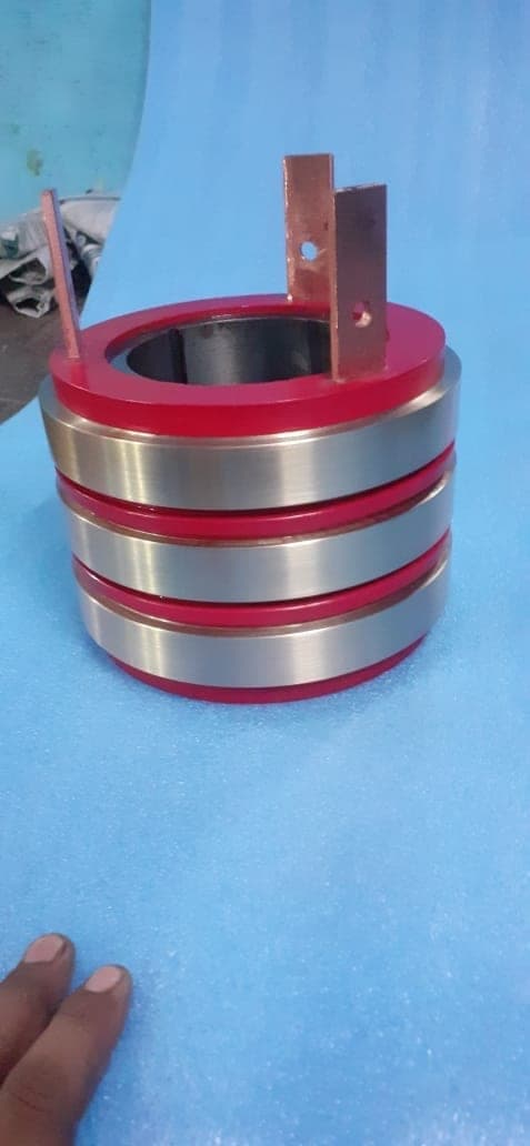 Red insulated steel slip ring with copper terminals manufactured by Heena Electric Corporation